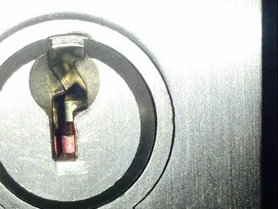 Key snapped off inside a door cylinder, the kind of damage a forced pick or key can cause