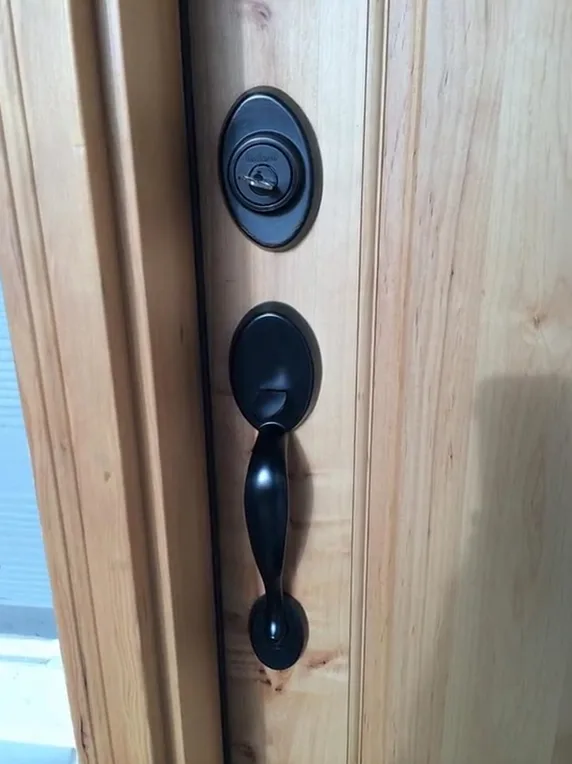 Matching deadbolt and handleset on a wood front door, both set to one key