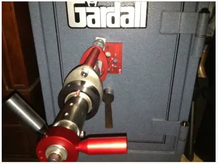 Drill rig mounted on a Gardall safe door during a safe opening job